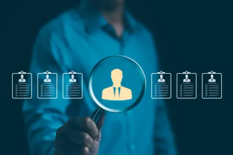 Szukamy idealnego kandydata. Lupa powiększa sylwetkę pracownika, pokazując, jak działa agencja pracy, dopasowując talenty do firm.