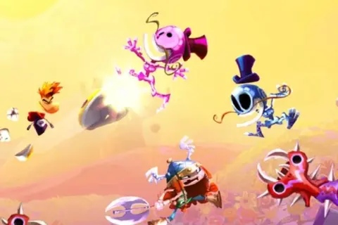 Kolorowa scena z gry Rayman, z postaciami w powietrzu i wrogami.