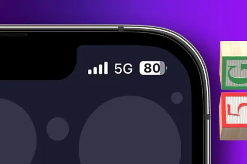 L'écran d'un iPhone 13 compatible 5G affiche le signal, la connexion 5G et le niveau de batterie. Deux blocs en bois avec les chiffres 5 et G sont à côté.