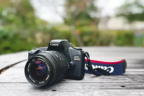 Canon EOS Rebel G film camera with a Quantaray 28-90mm lens, a classic choice for the best Canon 35mm film camera experience.