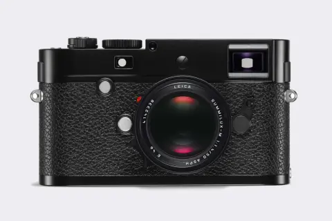 A classic black Leica 240 camera with a Summilux-M 50mm f/1.4 ASPH lens. This iconic camera is ready to capture timeless moments.