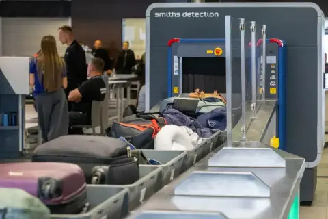 Bagaż podręczny na lotnisku przechodzi przez kontrolę bezpieczeństwa. Zastanawiasz się, ile wcześniej trzeba być na lotnisku?