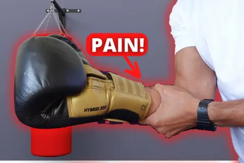 A boxer's forearm is being gripped, with a "PAIN!" graphic and arrow pointing to the wrist. Do strong forearms help you punch harder?