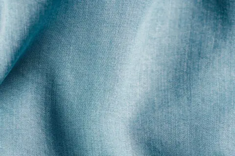 Blaues Lyocell-Gewebe mit feiner Webstruktur. Es ist lyocell elastisch und fühlt sich weich an.