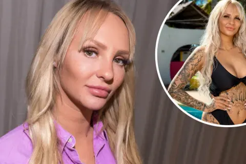 En ung kvinna med blont hår och tatueringar, klädd i en svart bikini, poserar vid en pool.