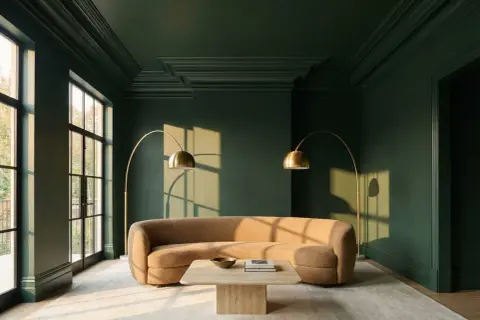 Elegant crown molding ideas enhance this dark green room, framing large windows and adding depth to the ceiling.