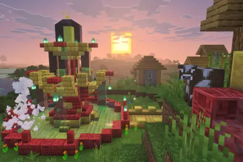 Wioska w Minecraft z nową aktualizacją. W centrum budowla z czerwonych i złotych bloków, obok krowa i domki.