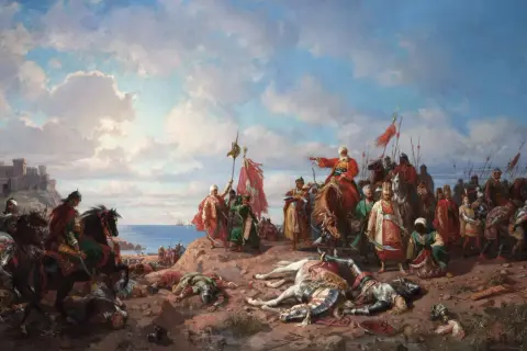 Soldados a caballo y a pie, con armaduras y estandartes, celebran una victoria en la costa. Un castillo se alza al fondo. Escena de la expansión del imperio otomano.