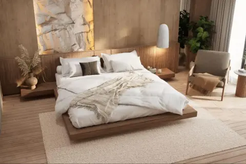Ideas para diseñar habitacion: cama baja de madera, pared de roca iluminada, silla acogedora y plantas.