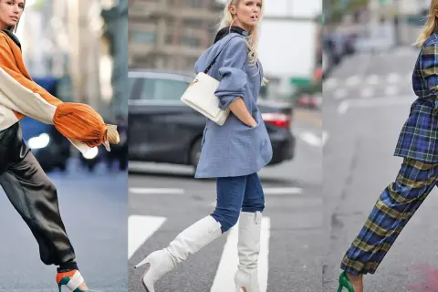 Tre donne sfoggiano eleganti outfit autunnali: un look con maniche arancioni e pantaloni satinati, uno con blazer azzurro e stivali bianchi, e uno con completo a quadri e décolleté verdi.