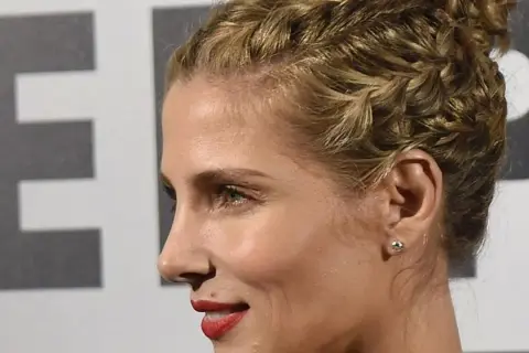 Peinado recogido coleta alta boda, con trenzas y labios rojos.