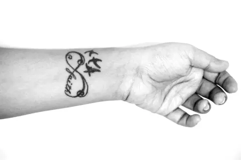 Ein beliebtes Tattoo für Frauen: Ein Unendlichkeitszeichen mit dem Wort "Faith" und drei fliegenden Vögeln auf dem Handgelenk.