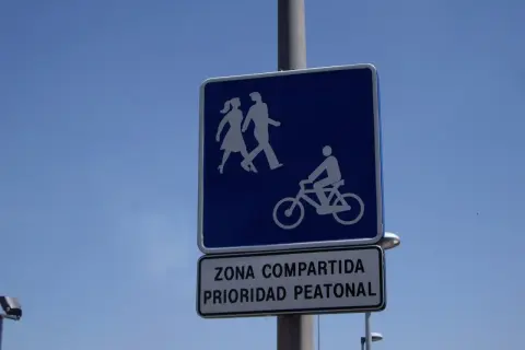Señal de carril bici compartido con peatones, indicando prioridad peatonal.