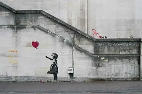 Banksy art piece: Girl letting go of a red heart balloon, with the words "THERE IS ALWAYS HOPE" stenciled above.