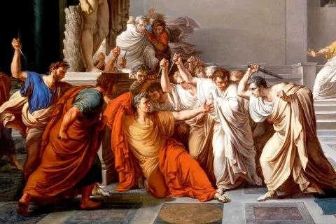 Män i toga omringar och attackerar Julius Caesar med knivar.