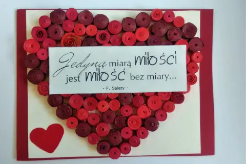 Walentynka dla chłopaka: serce z czerwonych spirali papieru i cytat "Jedyną miarą miłości jest miłość bez miary...".