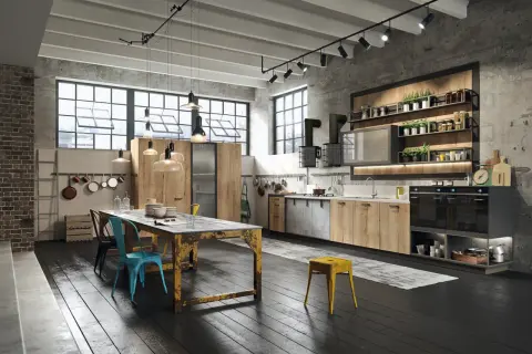 Nowoczesna kuchnia w stylu loft z drewnianymi frontami, betonową ścianą i industrialnymi lampami. Idealne miejsce na wspólne gotowanie.