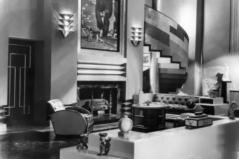 A luxurious Art Deco living room, showcasing the bold geometric style of the era's artists.