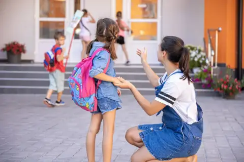 Mama żegna córkę idącą do szkoły. To już obowiązek szkolny 6-latków, czas na naukę i nowe przygody!