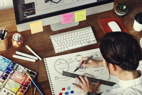 A graphic designer sketches logo ideas, a key step in learning how to make money as a graphic designer.