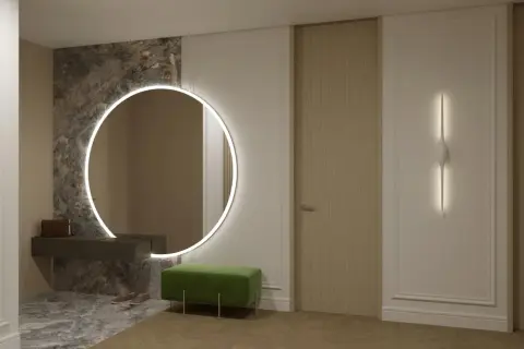 Eleganckie, duże lustro do przedpokoju z podświetleniem LED, wiszące nad ciemną konsolą. Obok zielona pufa i drzwi.