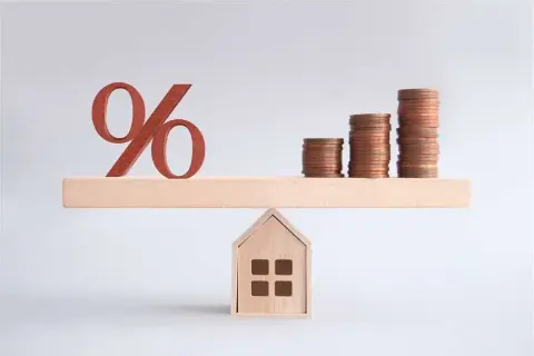 Bilancia con simbolo percentuale e pile di monete su una casa. Un'illustrazione su come comprare una casa.