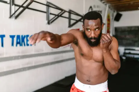 A man practices shadow boxing, demonstrating the physical and mental shadow boxing benefits.