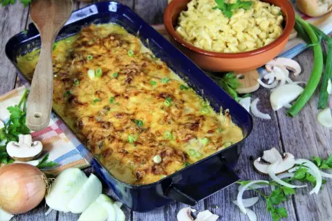 Zwiebel Sahne Schnitzel, überbacken mit Käse, daneben Spätzle, Zwiebeln und Pilze.