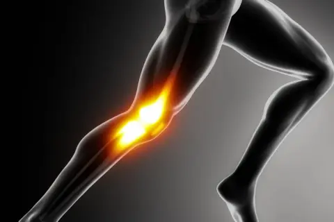 Anatomical illustration of a human leg with glowing knee joint.