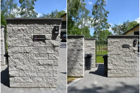 Solidne ogrodzenie z pustaków z wbudowaną skrzynką na listy i domofonem. Obok śmietniki i furtka.
