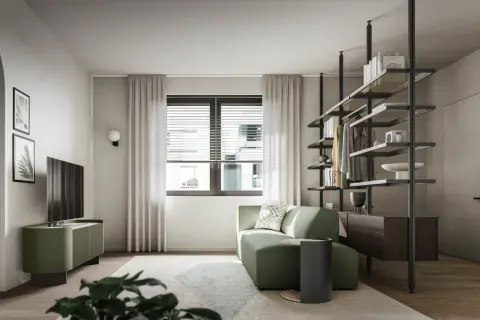 Divano verde smeraldo in un soggiorno moderno. Il verde sta bene con il legno scuro e i toni neutri, creando un'atmosfera rilassante.