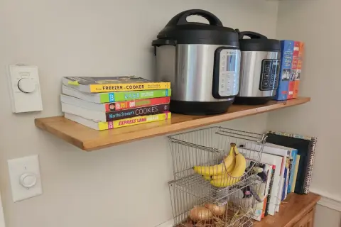 DIY floating shelves hold Instant Pots, cookbooks, and bananas.