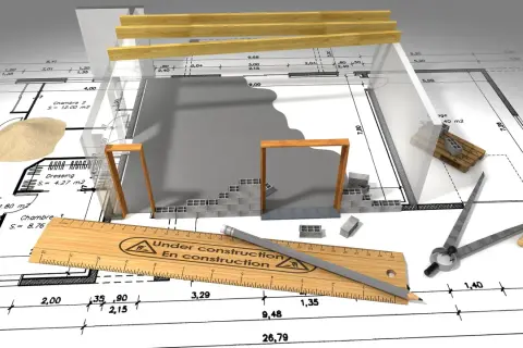 Budowa domu bez kredytu a urząd skarbowy: plan, materiały budowlane i narzędzia na tle projektu.