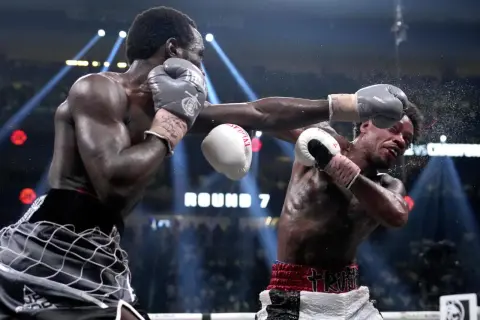 Boxer lands a powerful punch, showcasing one of the best shadow boxing finishers. The crowd roars as Round 7 begins.