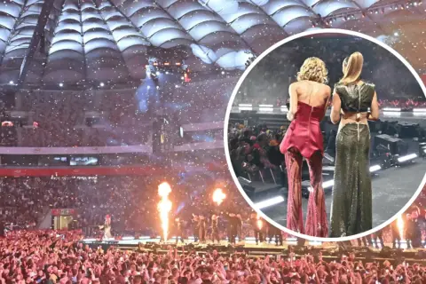 Koncert PGE Narodowy w deszczu konfetti. Dwie artystki w błyszczących strojach na scenie, tłum fanów w ekstazie.