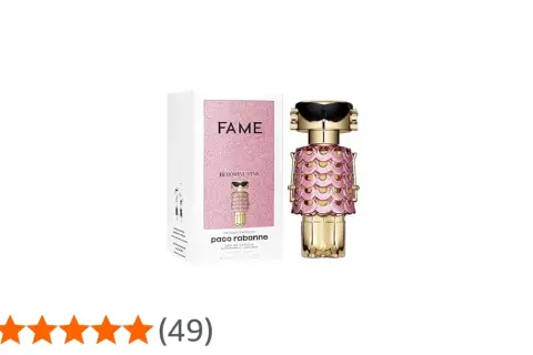 Paco Rabanne Fame Blooming Pink – złoty flakonik perfum w kształcie robota z różowymi łuskami i czarnymi okularami, obok pudełko.
