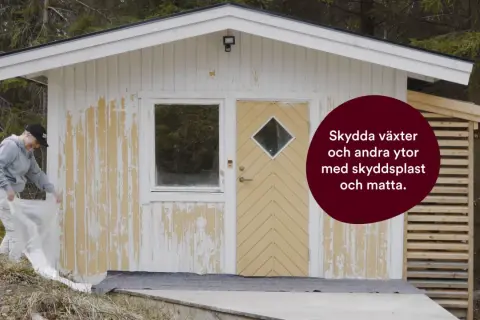 Kvinna skyddar växter med plast innan hon grundmålar utomhus.
