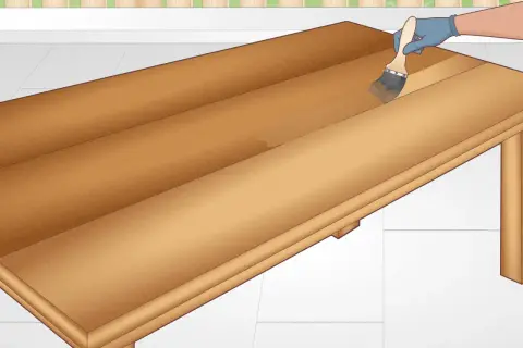 Applying a clear coat to a DIY table. The wooden surface is being brushed with a clear finish, enhancing its natural grain.