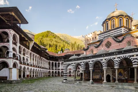 Piękna pogoda w Bułgarii we wrześniu. Rilski Monastyr z charakterystyczną architekturą i górami w tle.