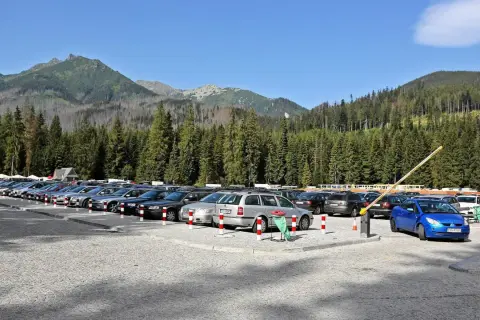 Parking pod Tatrami, tuż przed szlakiem na Morskie Oko. Samochody czekają na turystów.