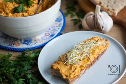 Pyszna pasta z kurczaka na kanapki, udekorowana kiełkami. Idealna na szybkie śniadanie lub przekąskę.