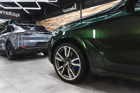 Błyszczące, zielone BMW i szare Porsche w garażu. Detailing co to? To dbałość o każdy szczegół, by auta lśniły jak nowe.