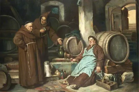 Monaci in una cantina con botti, forse dove è stata inventata la birra. Uno dorme, gli altri discutono.