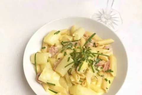 Cremige Spargel Carbonara mit Penne, Schinken und frischem Schnittlauch garniert. Ein Genuss für jeden Gaumen!