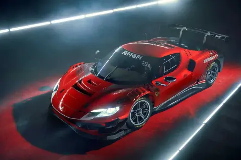 Czerwony Ferrari 296 GT3 z czarnym spojlerem i felgami, gotowy do wyścigu.