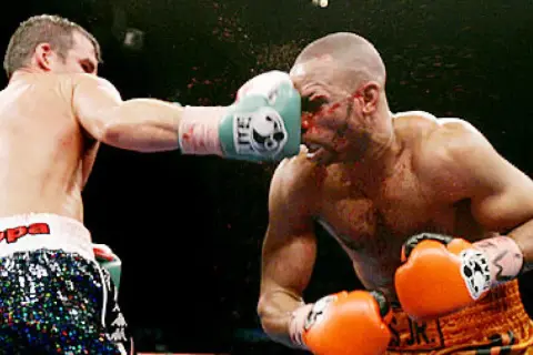 A boxer lands a punch on his opponent's face during the Joe Calzaghe vs Roy Jones Jr. fight.