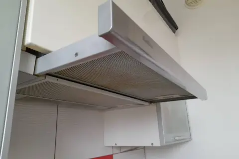 Metalowe filtry okapu kuchennego pokryte tłuszczem. Czas na czyszczenie!