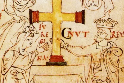 Ilustración medieval de Canuto el Grande, un rey con corona, señalando una cruz dorada.