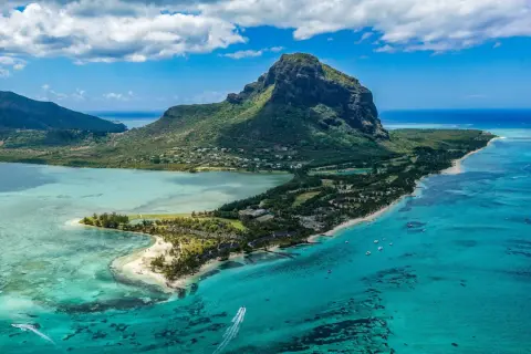 Rajska plaża na Mauritiusie, gdzie turkusowa woda i bujna zieleń zachęcają do relaksu. Pamiętaj o Mauritius szczepienia przed podróżą!