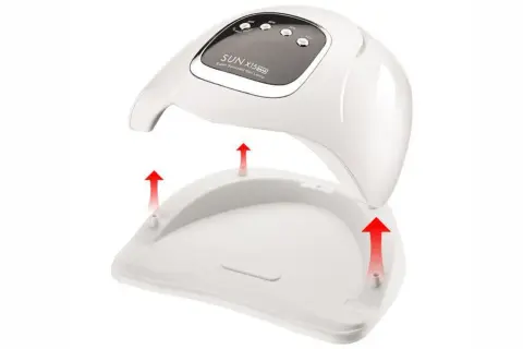 Biała lampa do paznokci hybrydowych SUN X15 MAX z odłączaną podstawą i czerwonymi strzałkami.